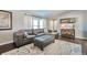 Bright living room with a sectional sofa and wood-look flooring at 11100 Haskell Creek Rd, Larkspur, CO 80118