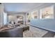 Open living room with view into kitchen and neutral color scheme at 11100 Haskell Creek Rd, Larkspur, CO 80118