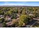 Aerial view of a residential neighborhood showcasing tree-lined streets and homes at 4157 Perry St, Denver, CO 80212