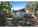 Backyard with detached garage, patio seating, and mature trees at 4157 Perry St, Denver, CO 80212