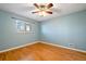 Bedroom features neutral-colored walls, hardwood floors, and a bright window at 4157 Perry St, Denver, CO 80212