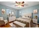 Comfortable bedroom featuring a plush bed, wooden floors, a window and contemporary furnishings at 4157 Perry St, Denver, CO 80212