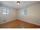 Bright bedroom with hardwood floors and two windows at 4157 Perry St, Denver, CO 80212