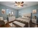 Spacious bedroom with light blue walls, hardwood floors, and ceiling fan at 4157 Perry St, Denver, CO 80212