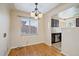 Bright dining area with hardwood floors, contemporary lighting, and a view into the kitchen at 4157 Perry St, Denver, CO 80212