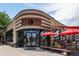 Attractive exterior view showcasing an architectural design and outdoor seating with vibrant red umbrellas at 4157 Perry St, Denver, CO 80212