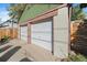 Detached two-car garage with white doors at 4157 Perry St, Denver, CO 80212