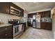 L-shaped kitchen with stainless steel appliances and granite countertops at 4157 Perry St, Denver, CO 80212