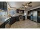 Kitchen with dark cabinetry, stainless steel appliances and granite countertops at 4157 Perry St, Denver, CO 80212