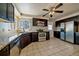 Modern kitchen with dark cabinetry, stainless steel appliances, and granite countertops at 4157 Perry St, Denver, CO 80212