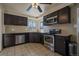 Kitchen boasts dark cabinetry, stainless steel appliances, and granite countertops at 4157 Perry St, Denver, CO 80212