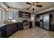 Kitchen with dark cabinetry, stainless steel appliances, and granite counters at 4157 Perry St, Denver, CO 80212