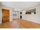 Living area flows into dining and kitchen, featuring hardwood floors and natural lighting at 4157 Perry St, Denver, CO 80212