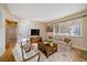 Cozy living room with hardwood floors, area rug, and comfortable seating by a large window at 4157 Perry St, Denver, CO 80212