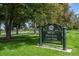 Rocky Mountain Lake Park sign amidst green lawns and trees, inviting visitors to enjoy the scenic surroundings at 4157 Perry St, Denver, CO 80212