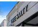 Close-up of a building's exterior displaying 'THE SALTY' signage against a clear blue sky at 4157 Perry St, Denver, CO 80212