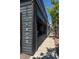 Storefront featuring a rustic-chic exterior with wood paneling, large vertical signage and a vibrant street scene at 4157 Perry St, Denver, CO 80212