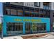 Bright blue storefront with eye-catching yellow lettering and large windows showcasing the interior at 4157 Perry St, Denver, CO 80212