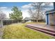 Picturesque backyard with a wooden deck, lush lawn, and privacy fencing, ideal for outdoor enjoyment at 12842 Bellaire St, Thornton, CO 80241