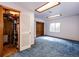 Finished basement space with blue carpeting, utility closet, and natural light from small window at 12842 Bellaire St, Thornton, CO 80241