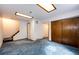 Spacious basement area with blue carpet, stairs, and ample space at 12842 Bellaire St, Thornton, CO 80241
