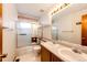 Bathroom featuring double vanity sinks with large mirror and shower over tub at 12842 Bellaire St, Thornton, CO 80241