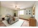 Digitally staged bedroom featuring neutral walls, carpet, and a window creating a warm and inviting space at 12842 Bellaire St, Thornton, CO 80241