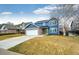 Charming two-story home with blue siding, brick accents, and a well-manicured lawn at 12842 Bellaire St, Thornton, CO 80241