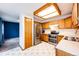 Well-lit kitchen boasting stainless steel appliances, wooden cabinetry, and an efficient layout at 12842 Bellaire St, Thornton, CO 80241