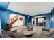 A staged living room with views to dining room and stairway to the second floor at 12842 Bellaire St, Thornton, CO 80241