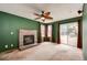Inviting living room featuring a brick fireplace, a ceiling fan, and a sliding glass door at 12842 Bellaire St, Thornton, CO 80241