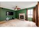 Comfortable living room showcasing a brick fireplace, a ceiling fan, and ample space for entertainment at 12842 Bellaire St, Thornton, CO 80241