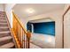 Bright living room with an open floor plan, light-colored carpet, and stairs leading to upper level at 12842 Bellaire St, Thornton, CO 80241