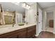 Bathroom featuring double sinks with granite counters and a glass shower at 30 S Ider Way, Aurora, CO 80018