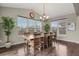 Bright dining room featuring a large table, hardwood floors, and abundant natural light from multiple windows at 30 S Ider Way, Aurora, CO 80018