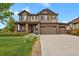 Beautiful two-story home boasting a three-car garage, manicured lawn, and impeccable curb appeal at 30 S Ider Way, Aurora, CO 80018
