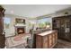 Warm living room with a brick fireplace, hardwood floors, custom wood cabinet and an open layout at 30 S Ider Way, Aurora, CO 80018