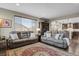 Comfortable living room with plush seating, a large window, and an open layout to the kitchen at 30 S Ider Way, Aurora, CO 80018