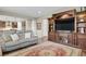 Spacious living room featuring hardwood floors, a large entertainment center, and an open floor plan at 30 S Ider Way, Aurora, CO 80018