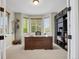 Bright home office features a large desk, built-in bookshelves, and a bay window at 30 S Ider Way, Aurora, CO 80018