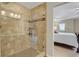 Tiled shower with built in shelving and glass door in primary bathroom at 30 S Ider Way, Aurora, CO 80018