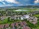 Wide aerial of community near a white modern church with lush green surroundings, lake, and mountain backdrop at 5836 S Vivian Way, Littleton, CO 80127