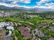 Stunning aerial view of a community featuring mountain views, a greenbelt, and walking paths under a blue, cloud-filled sky at 5836 S Vivian Way, Littleton, CO 80127