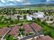 Wide aerial of community near a white modern church with lush green surroundings, lake, and mountain backdrop at 5836 S Vivian Way, Littleton, CO 80127