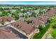 Aerial view showcases the community's well-planned streets, landscaping, and diverse home styles under a clear sky at 5836 S Vivian Way, Littleton, CO 80127