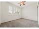 Bright bedroom with large windows, carpet, and a ceiling fan at 5836 S Vivian Way, Littleton, CO 80127