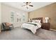 Inviting bedroom with carpet, shutters, ceiling fan, stylish lamps, and a decorative accent wall at 5836 S Vivian Way, Littleton, CO 80127