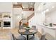 A dining room is adjacent to the kitchen and a living room, with a central dark wood table for entertaining at 5836 S Vivian Way, Littleton, CO 80127