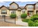 Charming townhouse featuring a landscaped front yard, steps to the front door, and decorative touches at 5836 S Vivian Way, Littleton, CO 80127