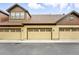 Exterior shot of garages with painted doors on a sunny day at 5836 S Vivian Way, Littleton, CO 80127